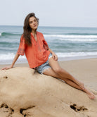 A model wears a Rose and Rose embroidered Antibes top in coral cotton.