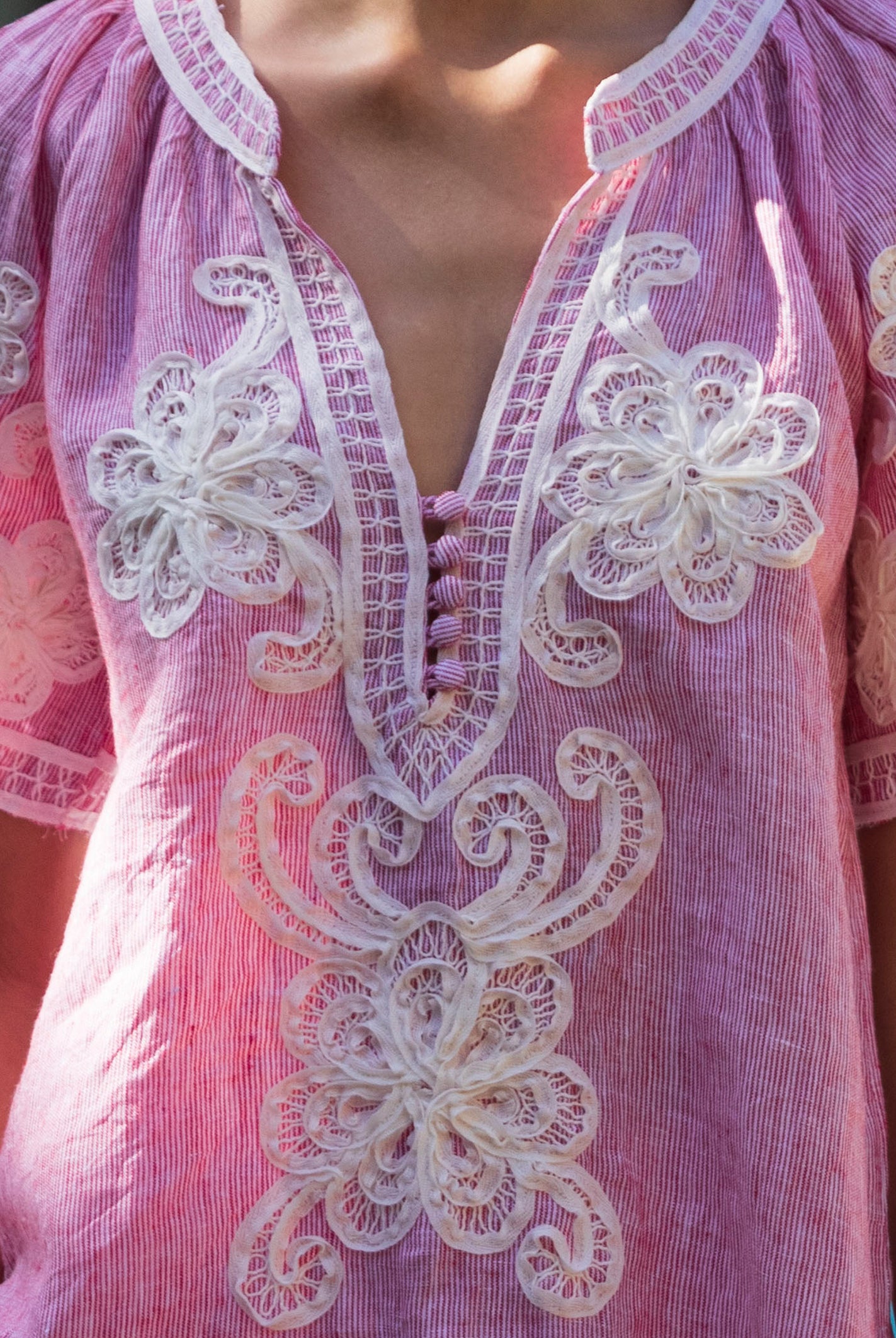 Close up details of the red striped Azalea blouse with white tape embroidery