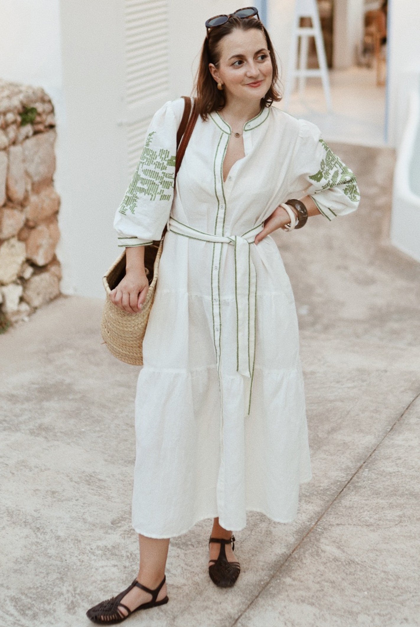 Influencer @launneden wearing the Pine white dress with olive green embroidery.