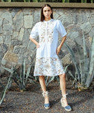 A model wearing a Rose and Rose Bond embroidered dress in white cotton.