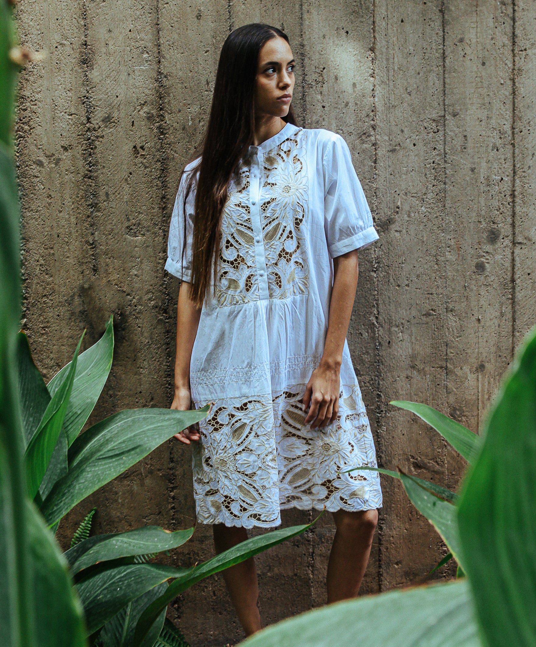 A model wearing a Rose and Rose Bond embroidered dress in white cotton.