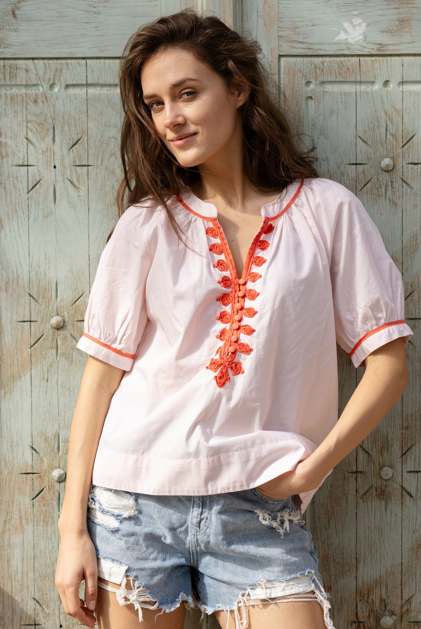 A model wears a Rose and Rose green cotton Cote D'Azur top with passementerie decoration.