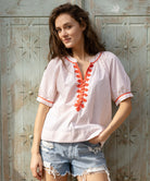 A model wears a Rose and Rose green cotton Cote D'Azur top with passementerie decoration.