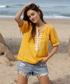 Model wears Rose and Rose yellow cotton Cote D'Azur top with passementerie decoration.