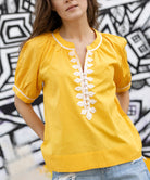 Close up details of the passementerie decoration on the Rose and Rose yellow cotton Cote D'Azur top.