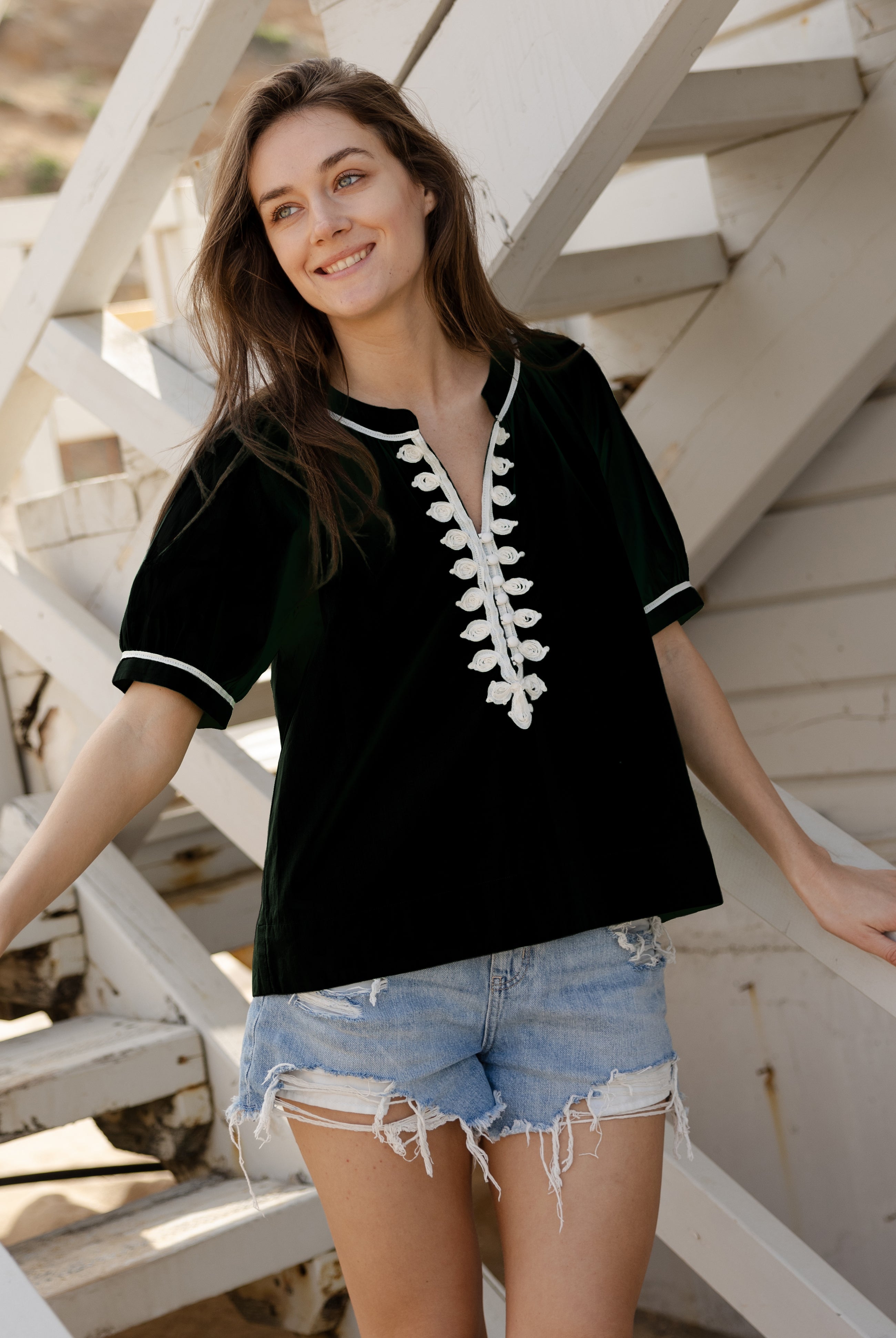 A model wears a Rose and Rose Cote D'Azure top in black.