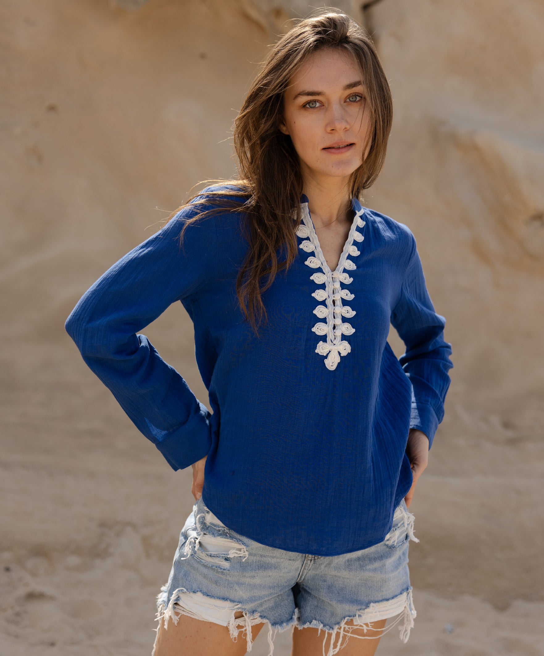A model wears the Rose and Rose blue Dinard shirt with passementerie decoration.