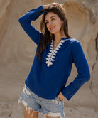 A model wears the Rose and Rose blue Dinard shirt with passementerie decoration.