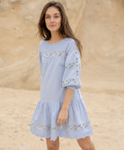 A model wearing a Rose and Rose blue cotton La Rochelle dress.