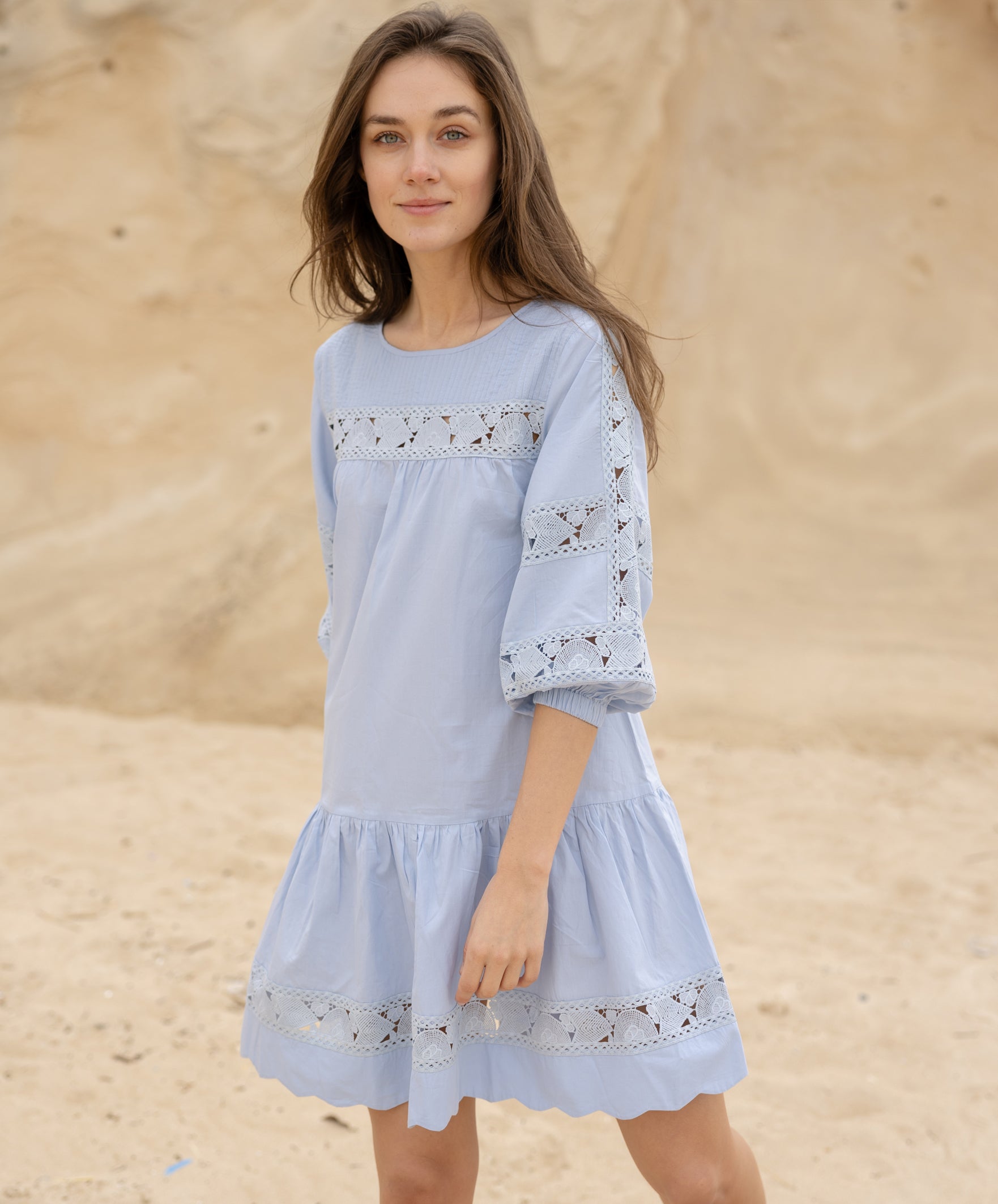 A model wearing a Rose and Rose blue cotton La Rochelle dress.