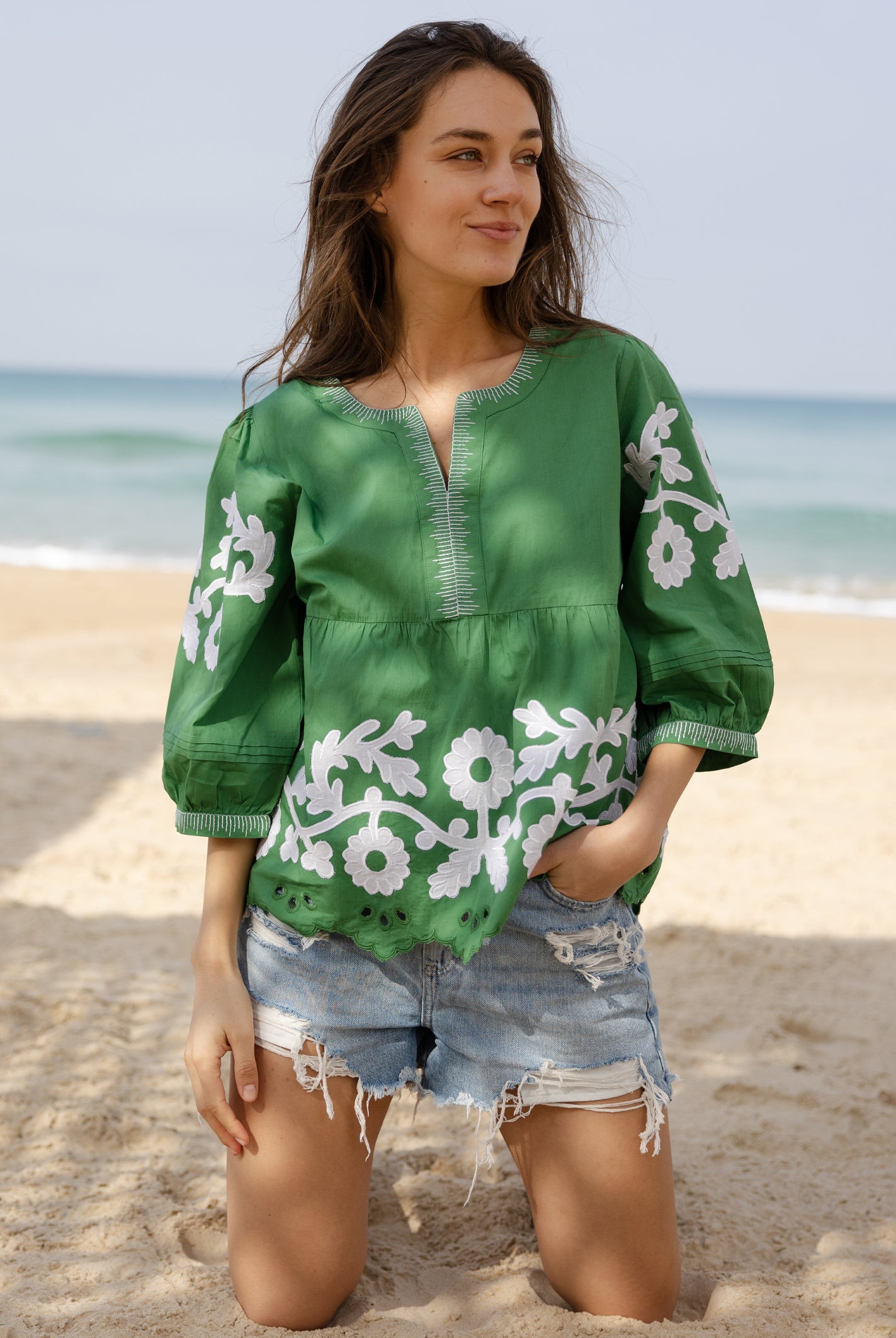A model wearing a Rose and Rose Nantes cotton top in leaf green.