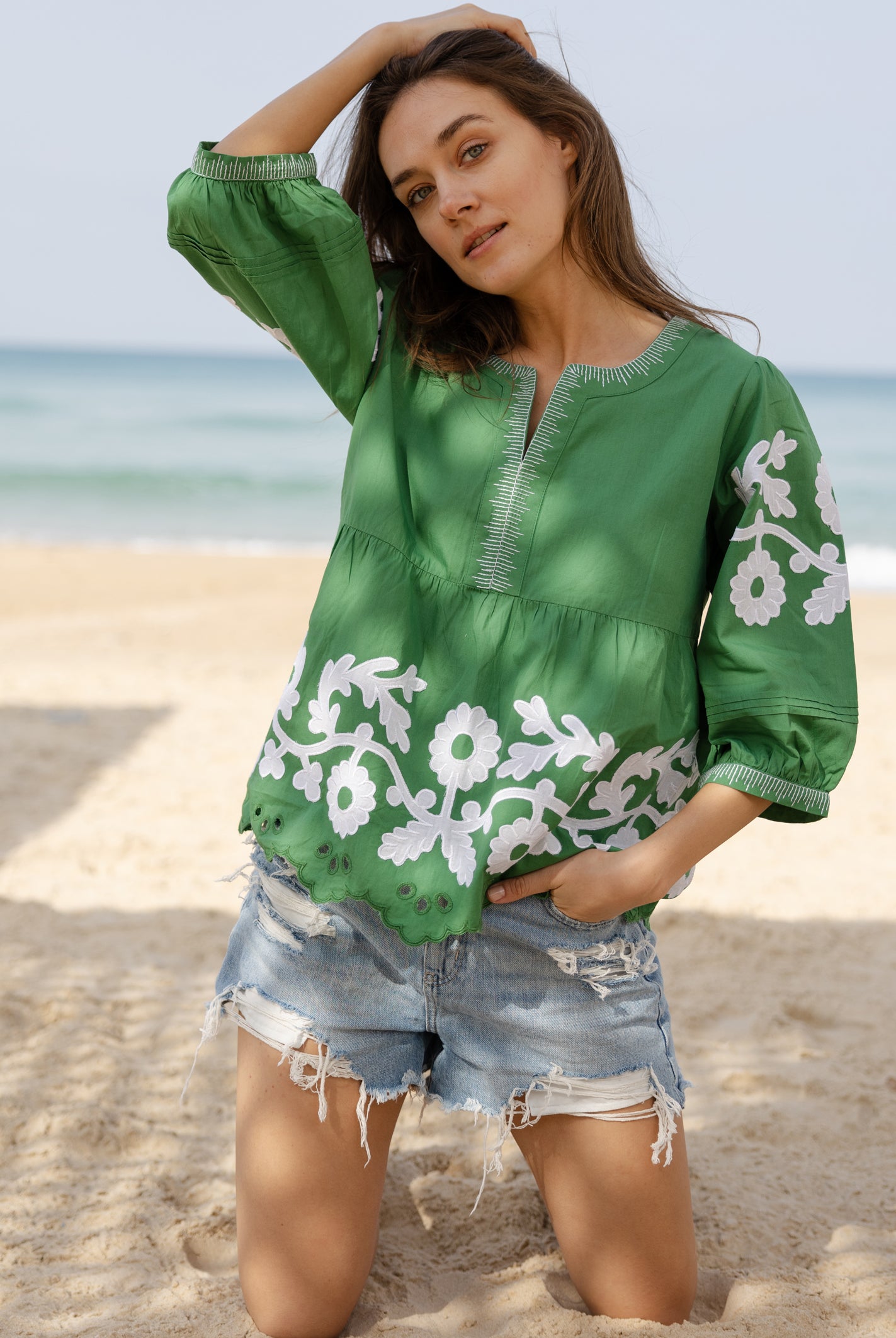 A model wearing a Rose and Rose Nantes cotton top in leaf green.