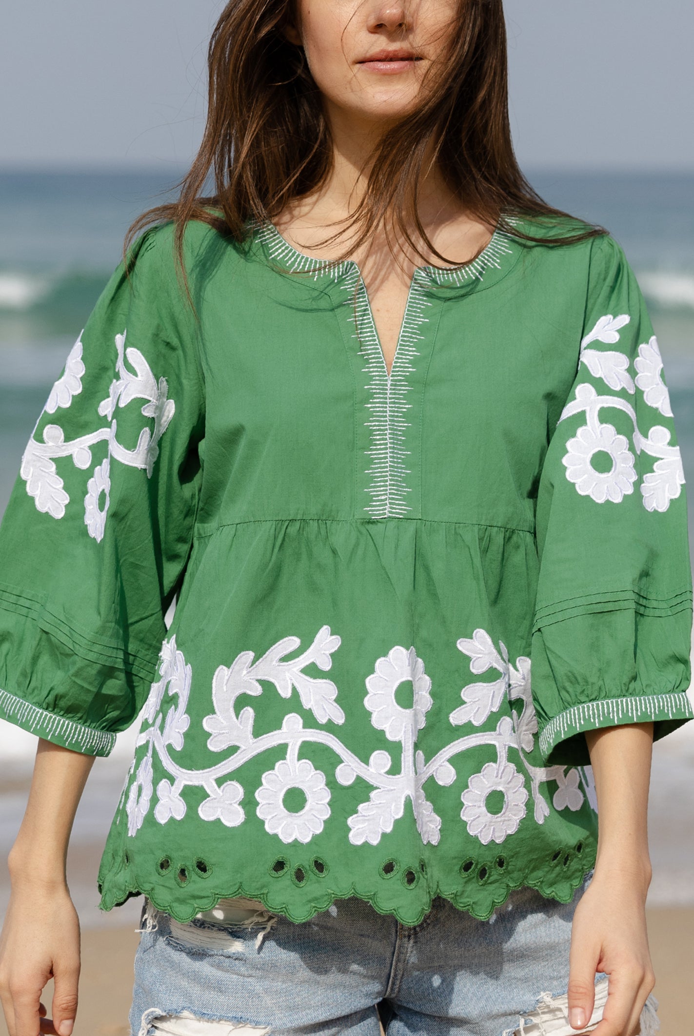 Details of the applique embroidery and pleats on the Rose and Rose Nantes green cotton top.