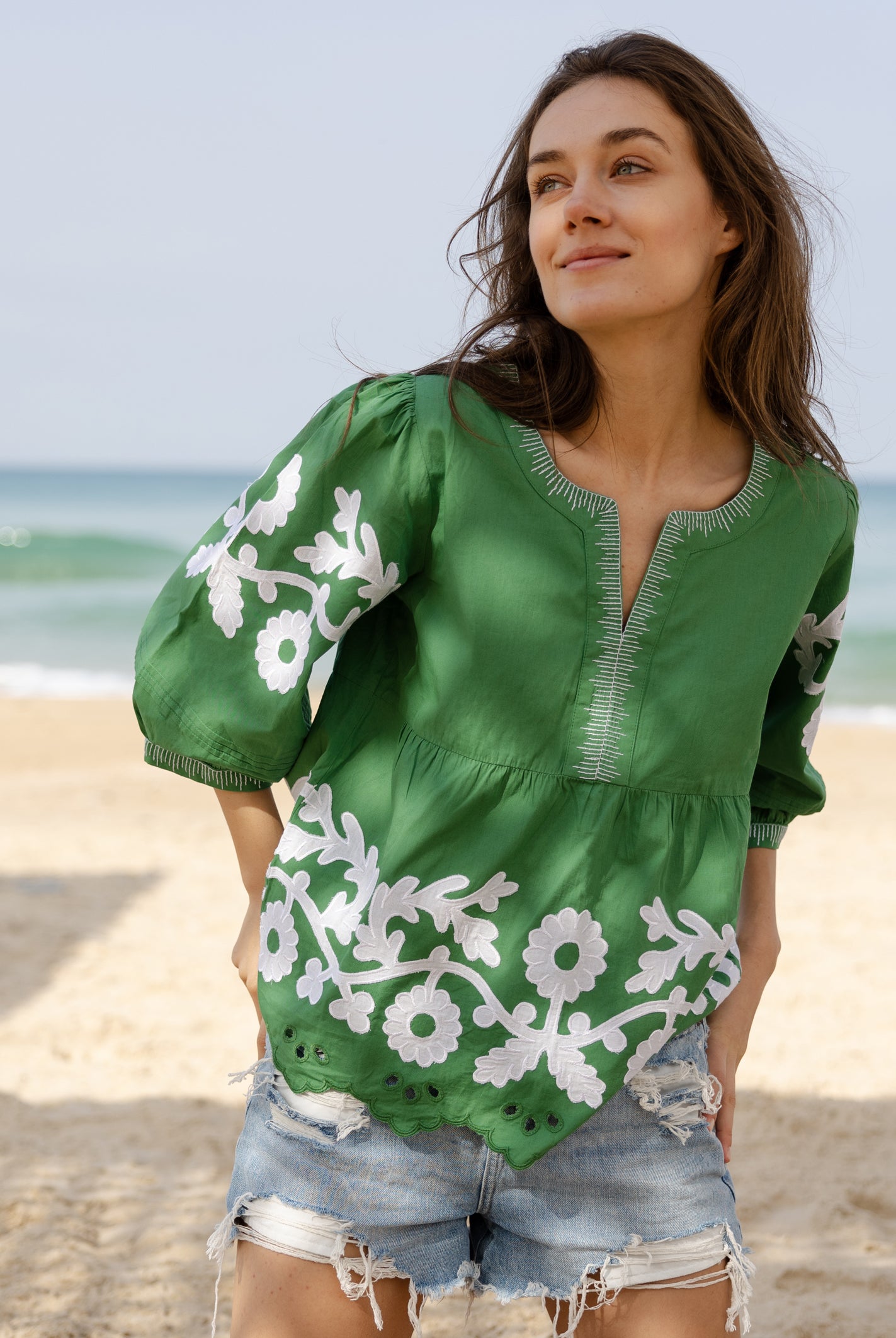 A model wearing a Rose and Rose Nantes cotton top in leaf green.