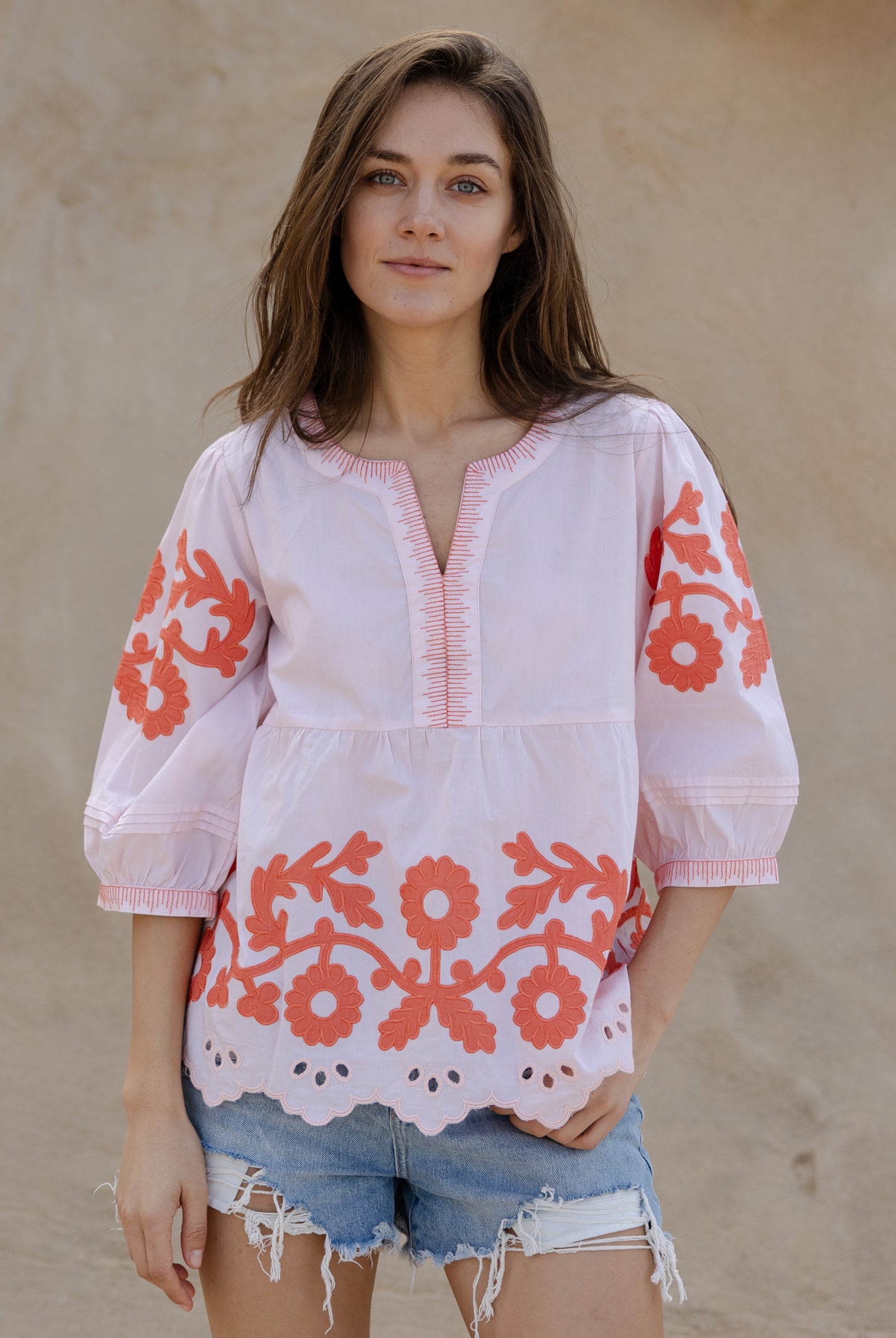 A model wearing a Rose and Rose Nantes top in shell pink cotton.