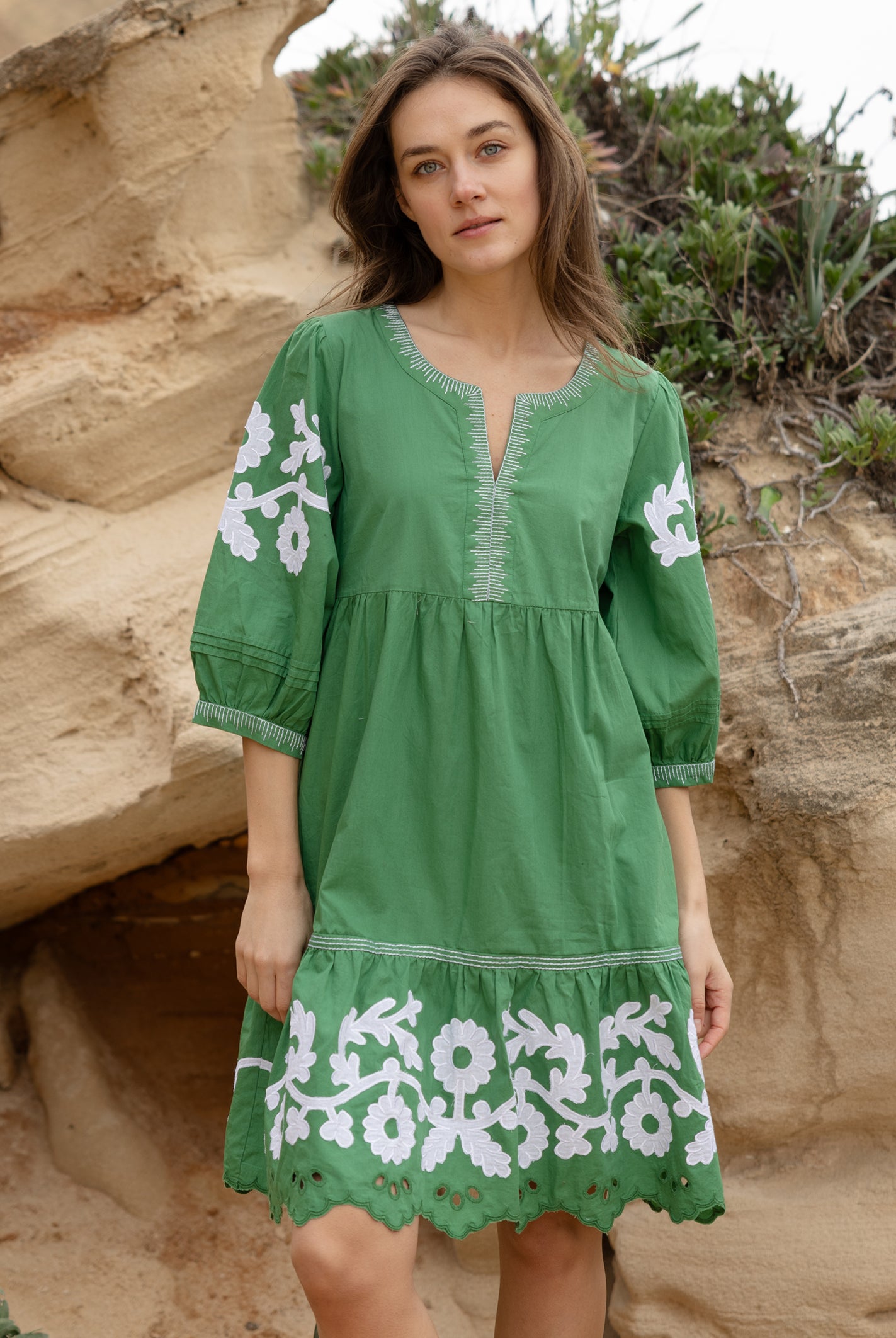 A model wearing a Rose and Rose Nice dress in leaf green cotton.