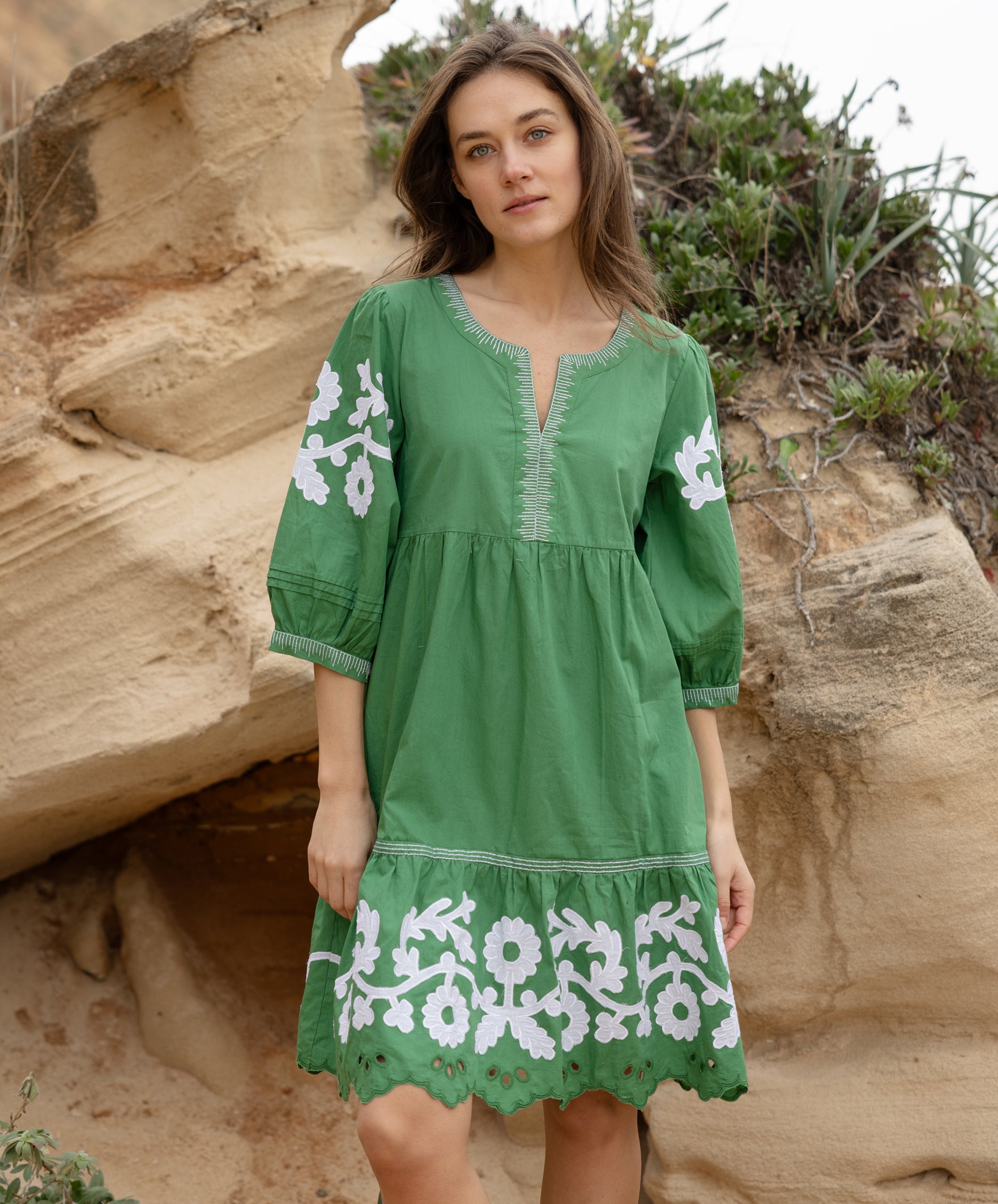 A model wearing a Rose and Rose Nice dress in leaf green cotton.