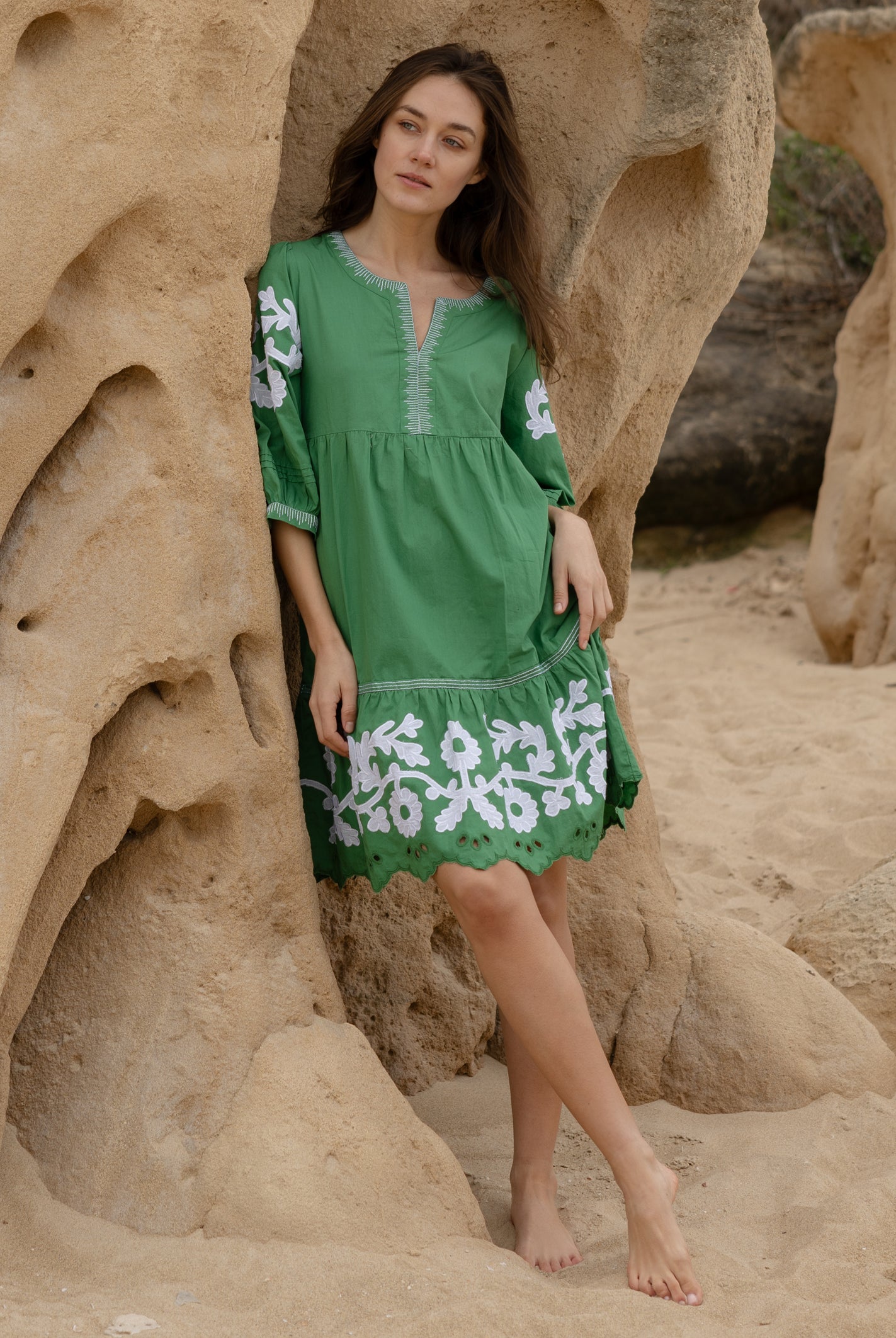 A model wearing a Rose and Rose Nice dress in leaf green cotton.