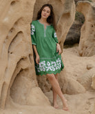 A model wearing a Rose and Rose Nice dress in leaf green cotton.