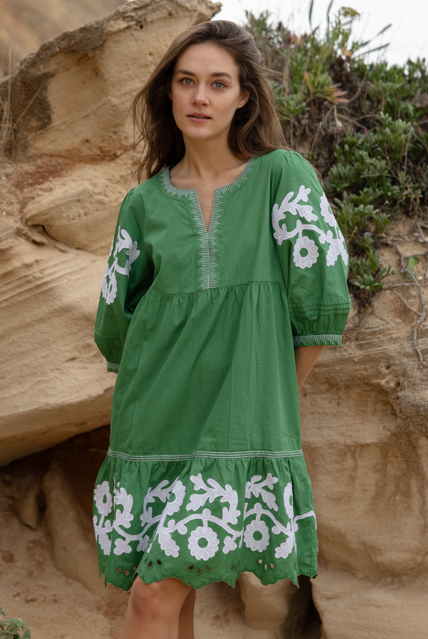 A model wearing a Rose and Rose Nice dress in leaf green cotton.