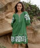 A model wearing a Rose and Rose Nice dress in leaf green cotton.