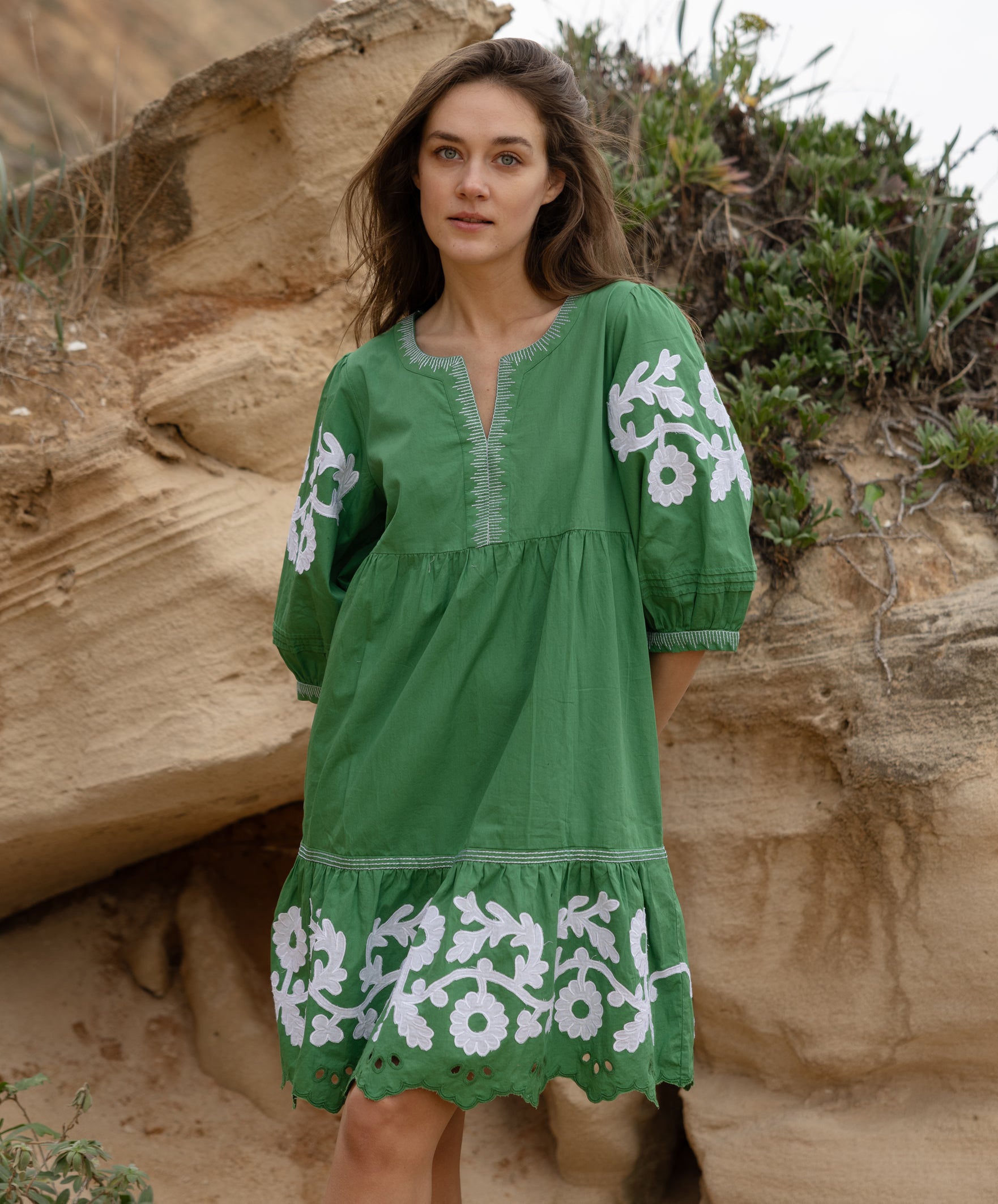 A model wearing a Rose and Rose Nice dress in leaf green cotton.