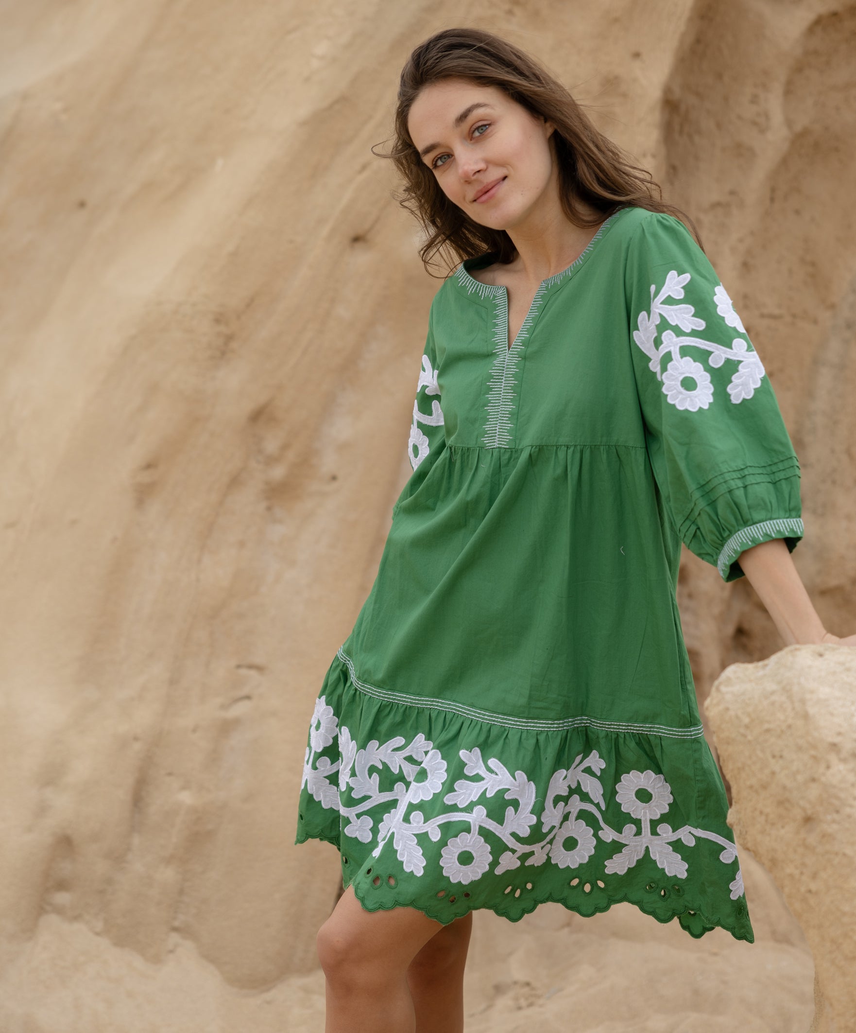 A model wearing a Rose and Rose Nice dress in leaf green cotton.