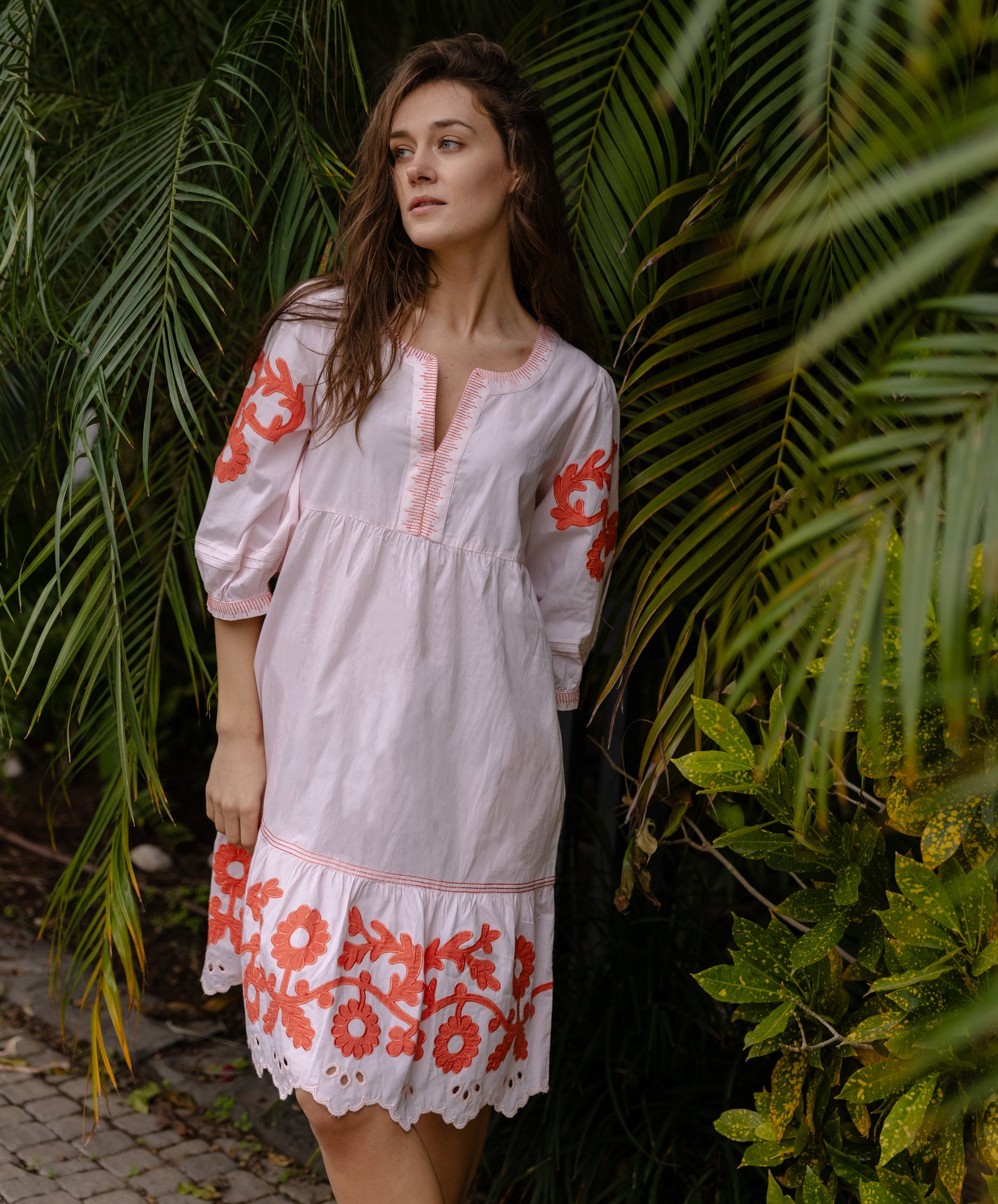 A model wearing a Rose and Rose Nice dress in shell pink cotton.