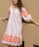 A model wearing a Rose and Rose Nice dress in shell pink cotton.