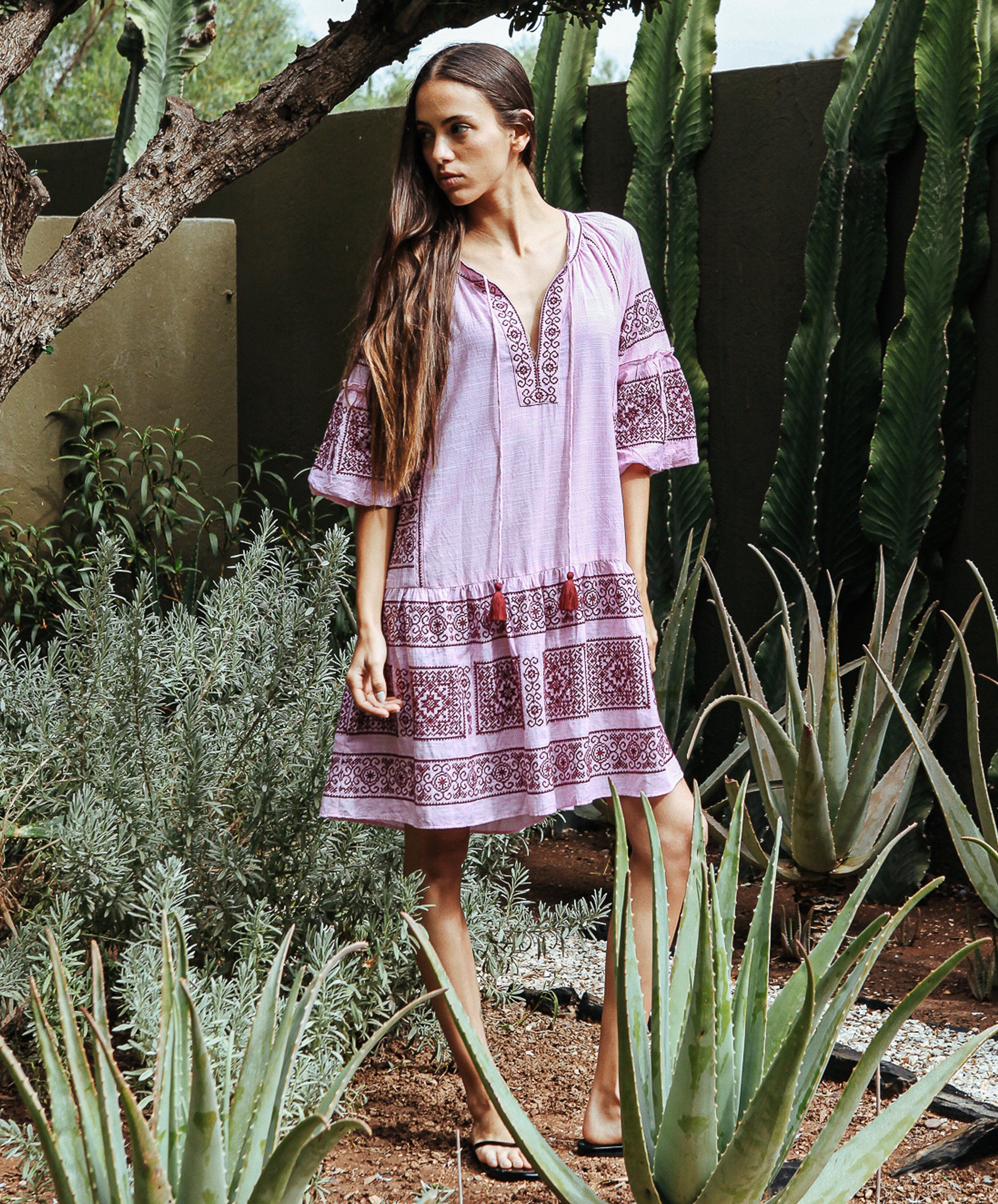 Model wearing a Rose and Rose embroidered Notting hill pink dress.