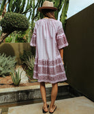 Back view of a model wearing a Rose and Rose embroidered Notting hill pink dress.