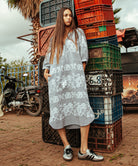 A model wearing a Rose and Rose Snaresbrook striped cotton dress with white embroidery.
