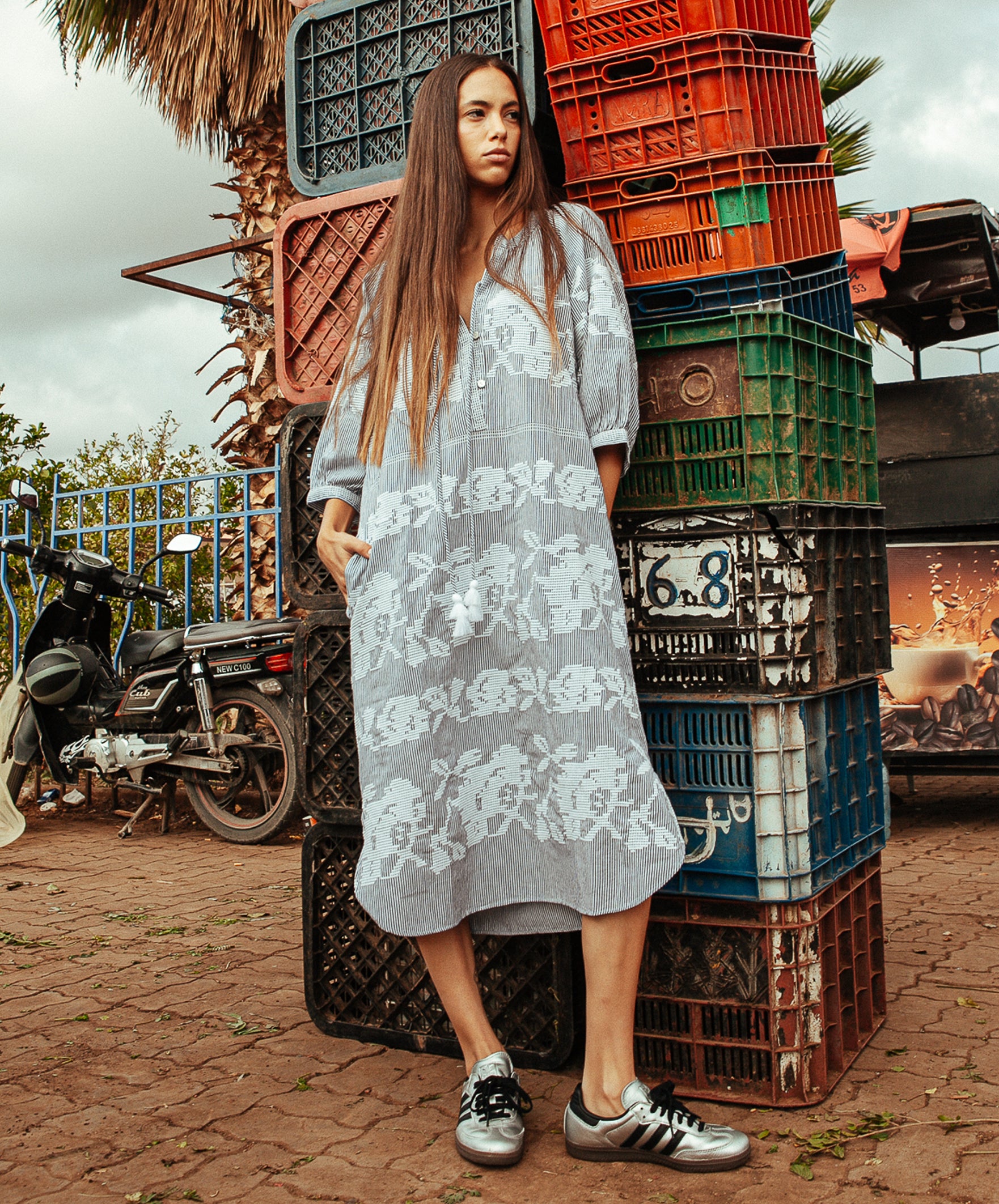 A model wearing a Rose and Rose Snaresbrook striped cotton dress with white embroidery.