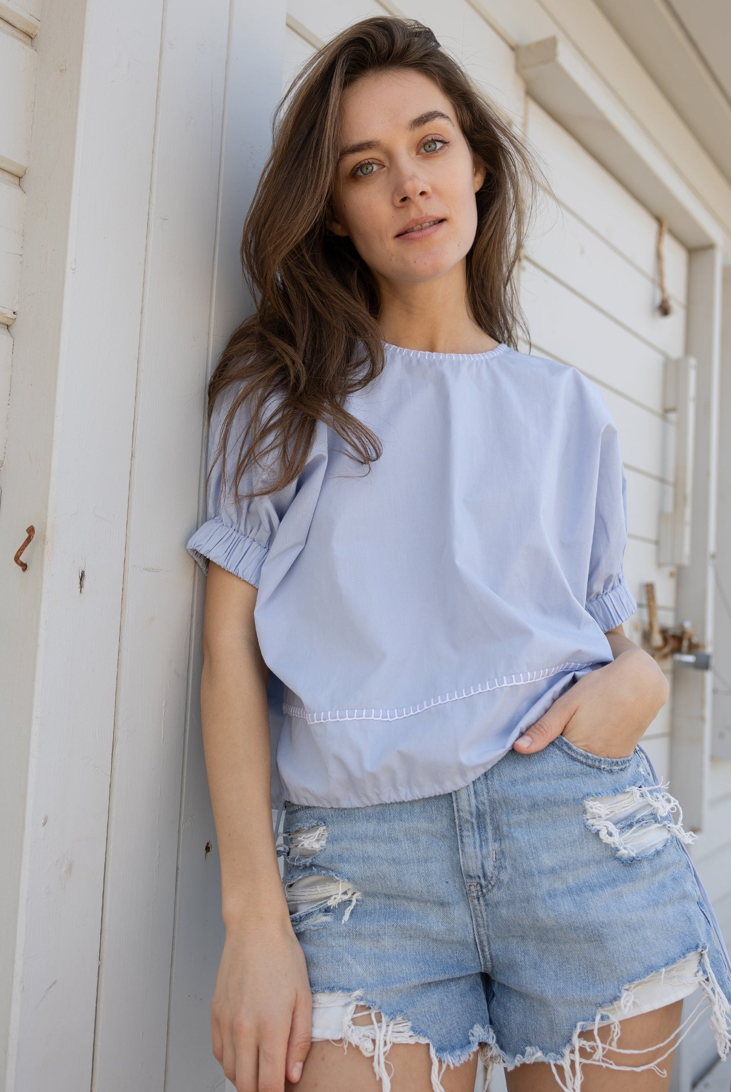 A model wears a Rose and Rose St. Tropez top in light blue cotton.