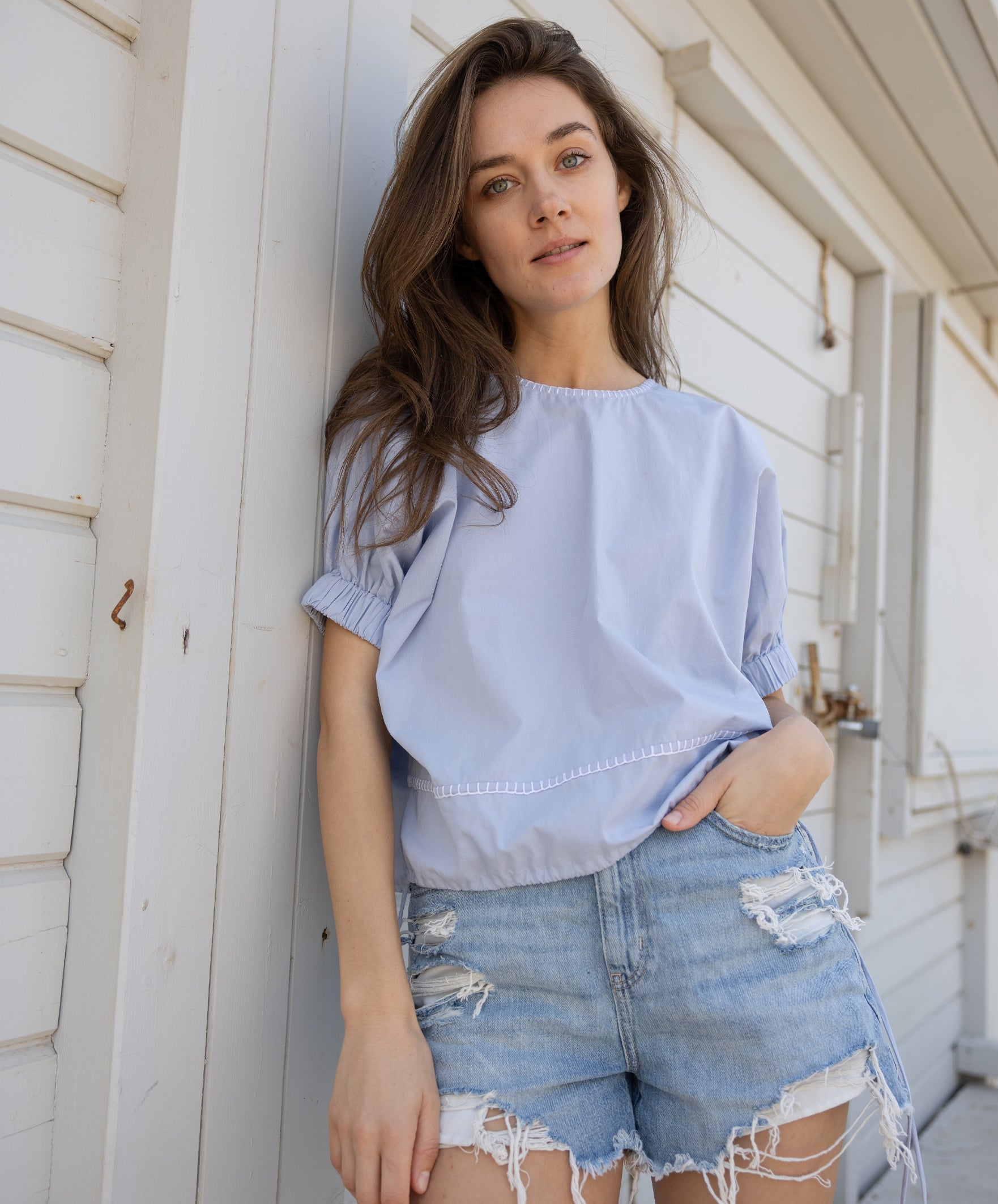 A model wears a Rose and Rose St. Tropez top in light blue cotton.