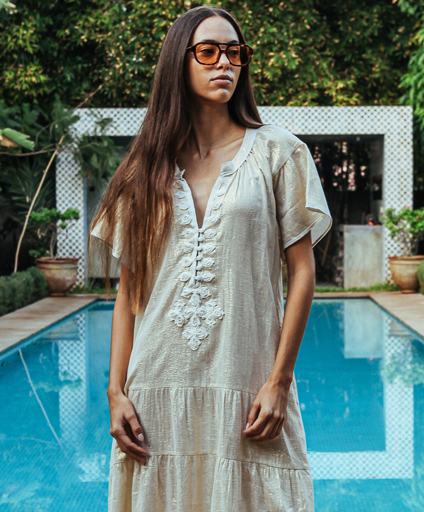 Details of the Rose and Rose Uxbridge gold dress with white passementerie decoration.