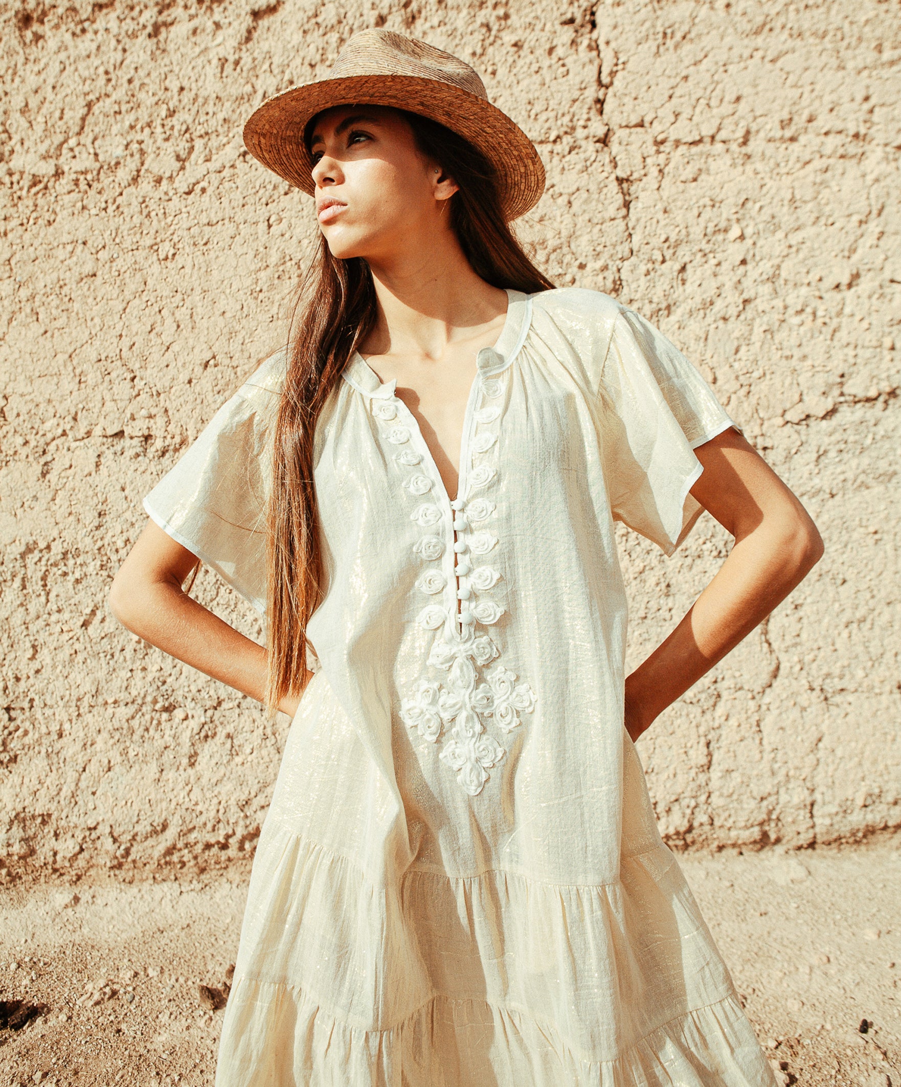 Details of the Rose and Rose Uxbridge gold dress with white passementerie decoration.