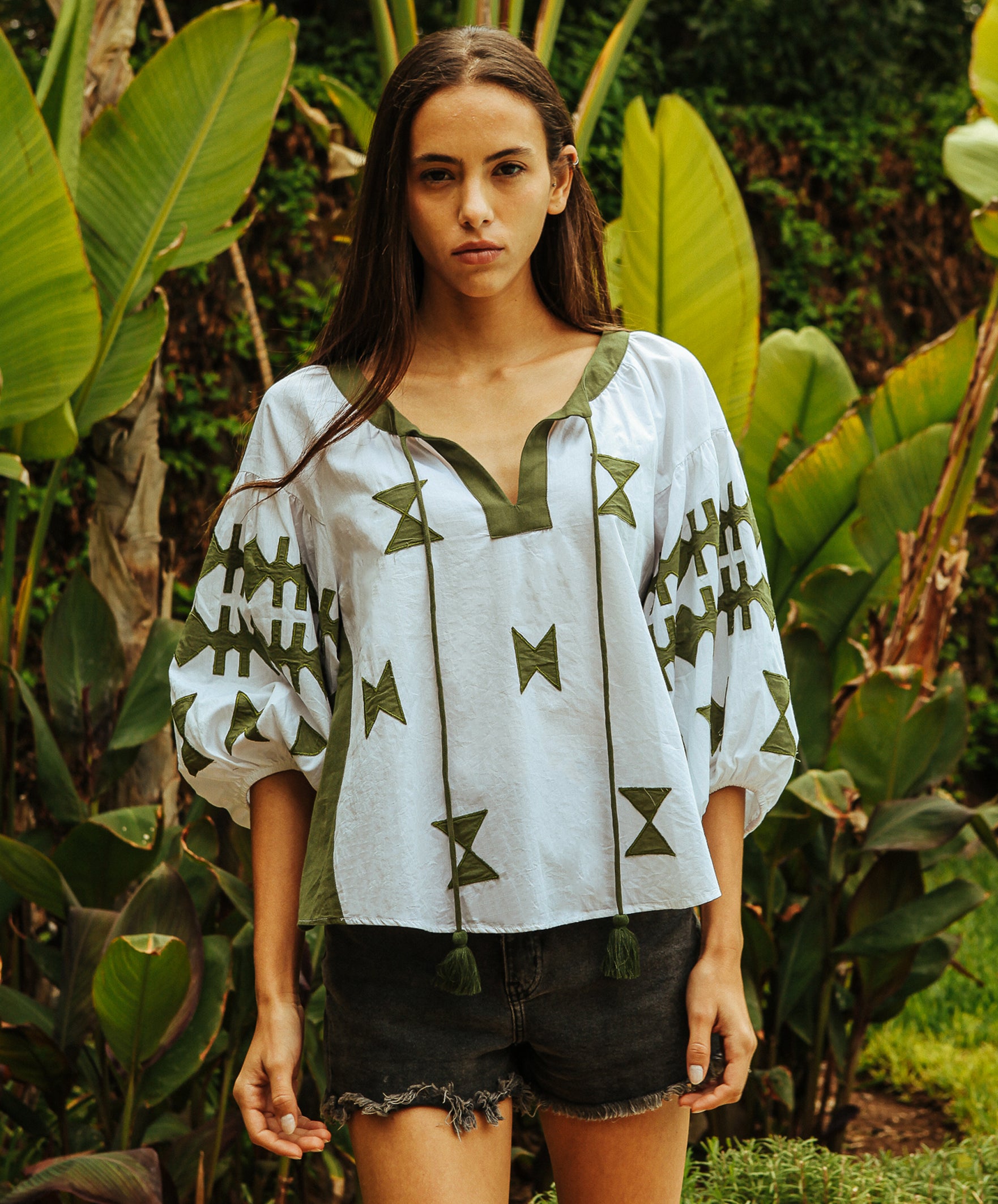 A model wears a Rose and Rose Aldgate top in white and olive cotton.