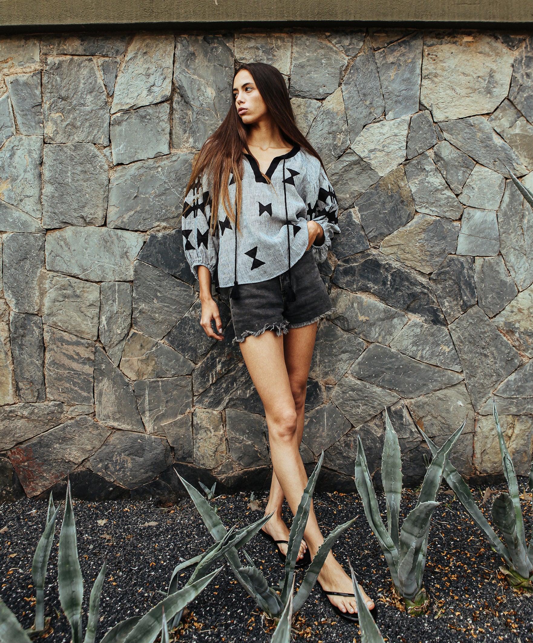 A model wearing a Rose and Rose striped linen Aldgate top. 