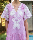 Details from the red striped Amaranta dress with white tape work decorations.  