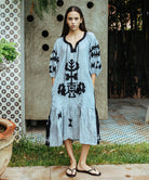 A model wearing a Rose and Rose Amersham striped linen dress. 