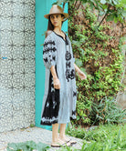 A side view of a model wearing a Rose and Rose Amersham striped linen dress. 