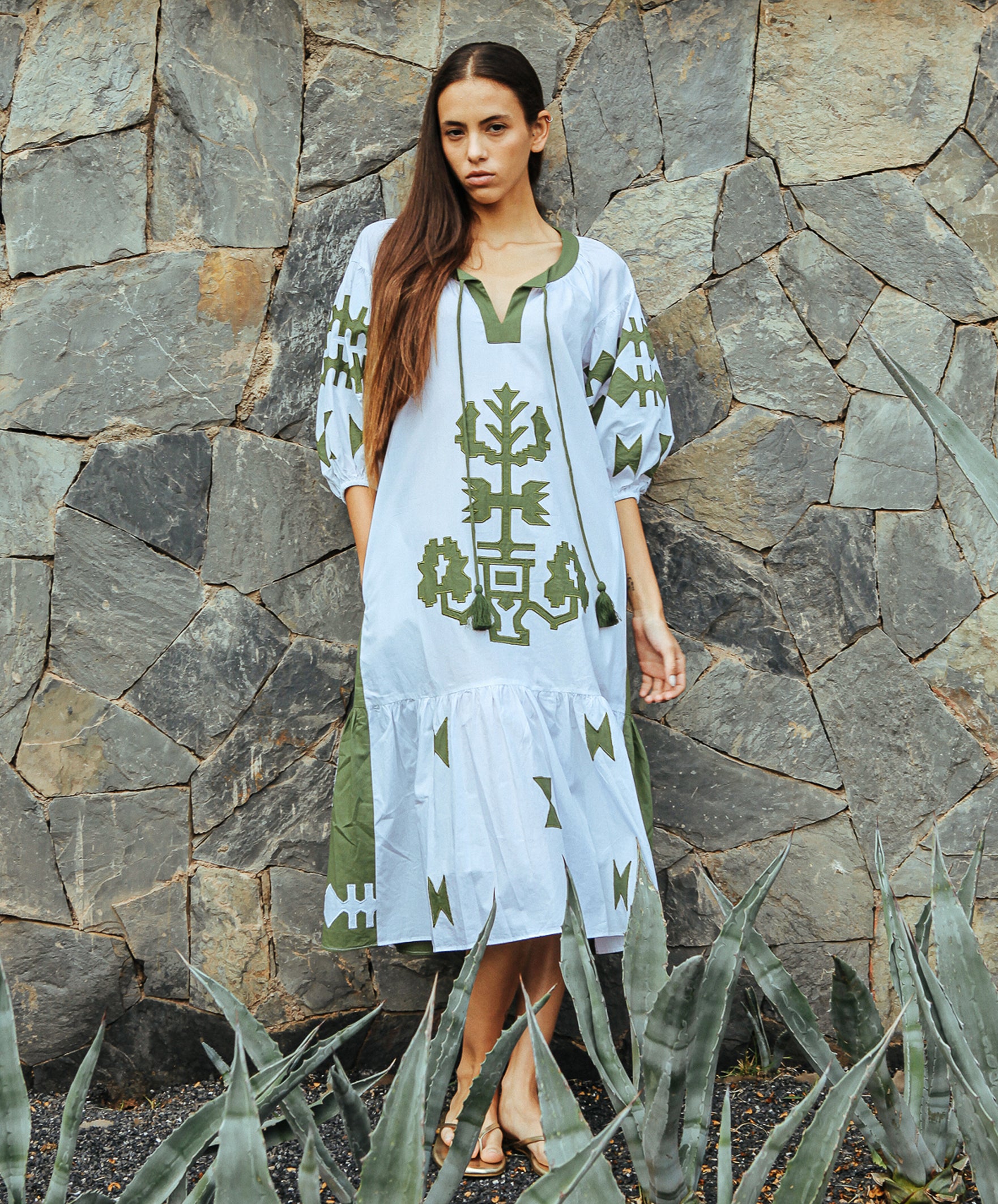 A model wearing a Rose and Rose Amersham dress in white and olive cotton.