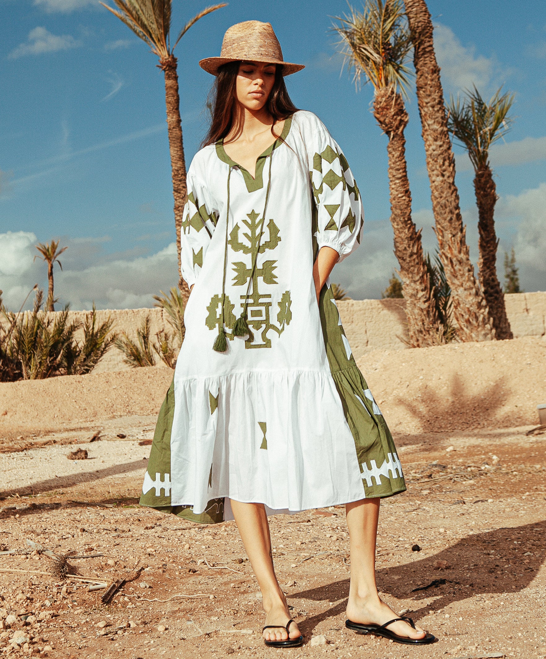 A model wearing a Rose and Rose Amersham dress in white and olive cotton.