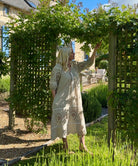 Influencer @shutters_and_stone stood admiring her garden wearing the Magnolia natural embroidered dress 