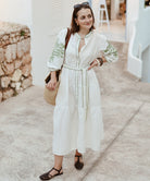 Influencer @launneden wearing the Pine white dress with olive green embroidery.