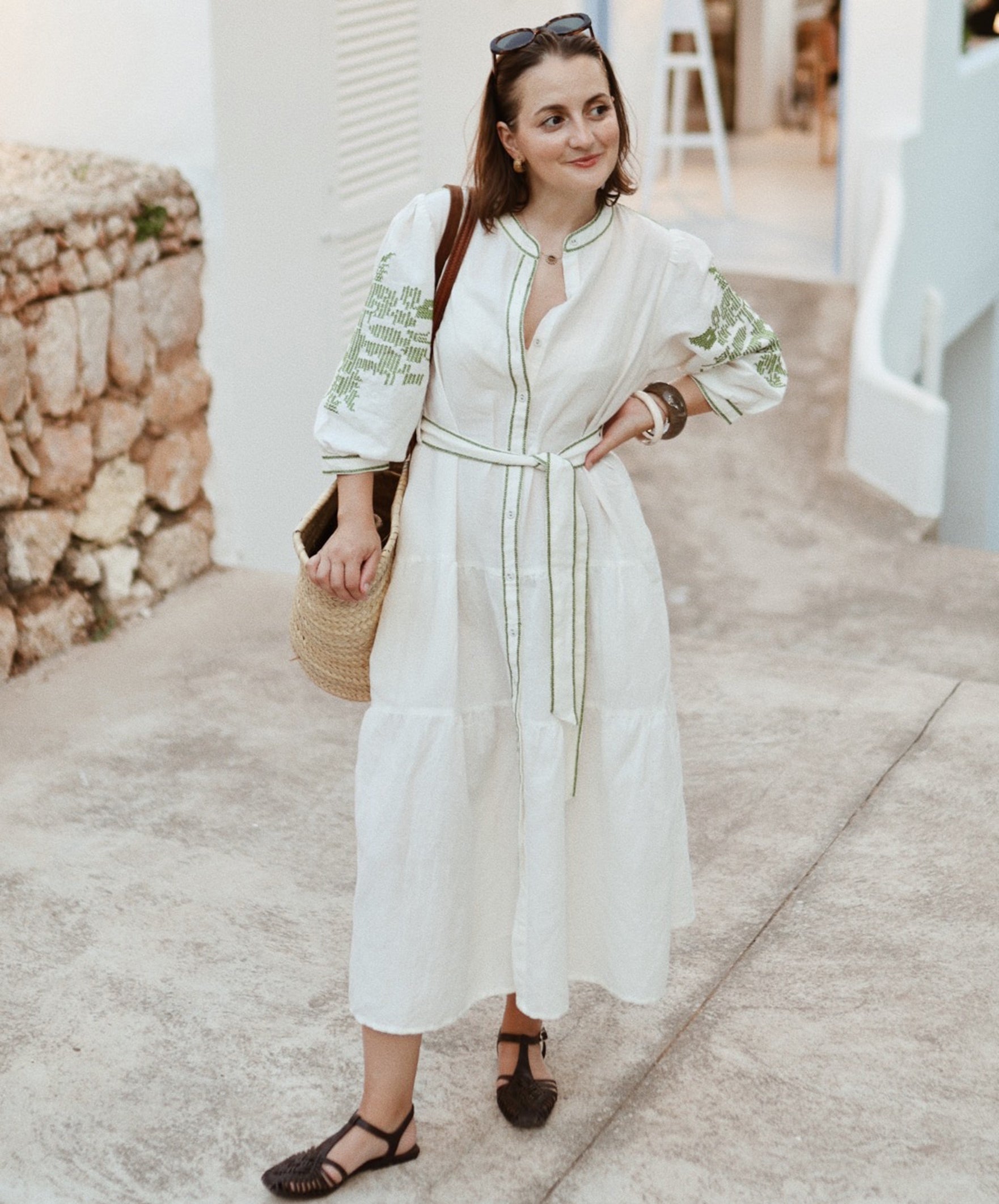 Influencer @launneden wearing the Pine white dress with olive green embroidery.