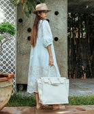 A model carrying a Rose and Rose large size beach bag.