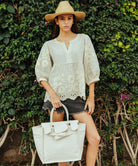 A model holding a Rose and Rose medium size beach bag.