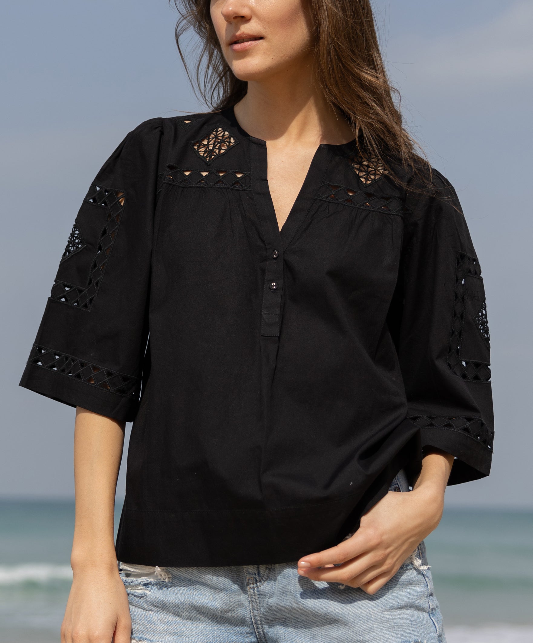 Details of the embroidery and cuts on the Bordeaux top. 